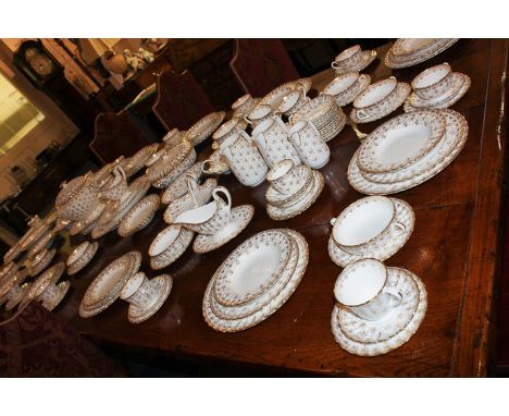 A large Spode gilt fleur de lys decorated porcelain dinner and tea service, for twelve settings (with some extras) to include