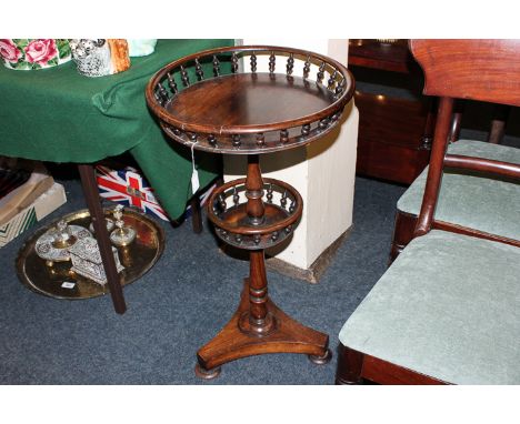 A 19th century rosewood two-tier table with circular galleried tiers and turned column on flat tripod base, 43cm diameter