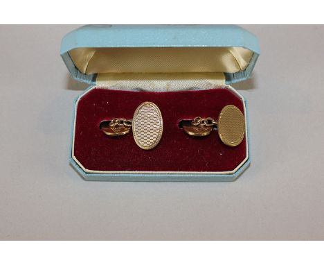A pair of 9ct gold oval cuff links with engine turned decoration, 12gms 