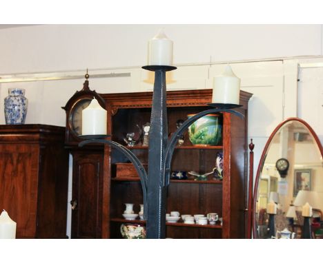 A mediaeval style wrought iron tall lamp with three pricket candle lights