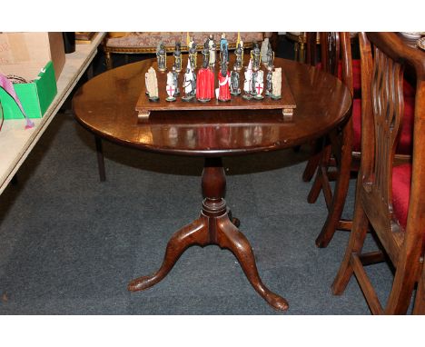 A mid 18th century mahogany tea table with circular tilting top on turned column and tripod base, 86cm diameter 