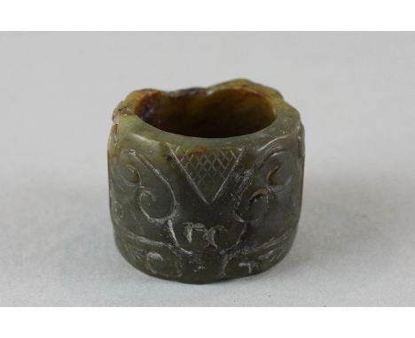 A jade ring with carved decoration, 3cm diameter