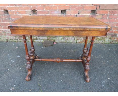A VICTORIAN WALNUT FOLD-OVER CARD TABLE WITH INLAID TUNBRIDGE WARE DETAIL, raised on four turned supports and carved scrollin