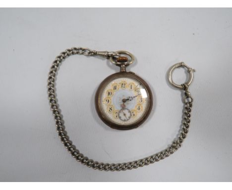 A CONTINENTAL .800 STAMPED SILVER OPEN FACED MANUAL WIND POCKET WATCH DECORATIVE  ENAMEL DIAL A/F ON SILVER PLATE CHAIN 