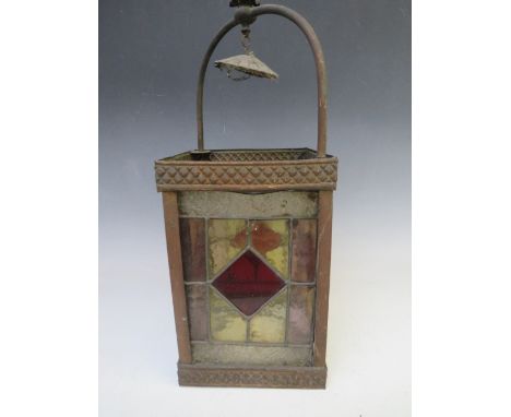 A DECORATIVE ARTS AND CRAFTS STYLE COPPER HANGING LANTERN, with glazed coloured and leaded panels, opening to one side, overa