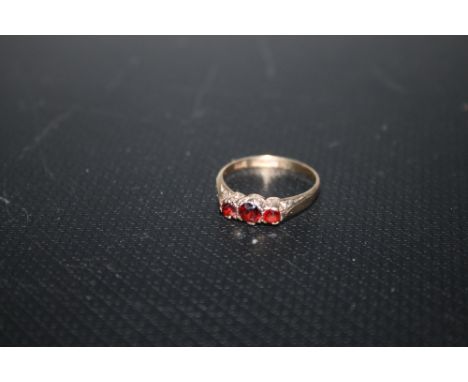 A HALLMARKED 9 CARAT GOLD THREE STONE GARNET RING, approx weight 1.7g, ring size k 1/2