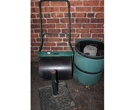 A COBRA LAWN ROLLER, A GARDEN WATER BUTT, A CAST PARASOL STAND AND A ROLL OF BARBED WIRE