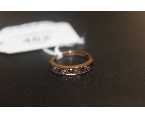 A HALLMARKED 9 CARAT GOLD GEM SET HALF ETERNITY RING  SET WITH RUBY AND DIAMOND STYLE STONES approx weight 2.7g ring size M 