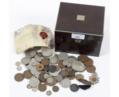 A rosewood tea caddy containing a collection of coins, including Churchill Crowns