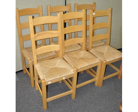 A set of six contemporary beech ladder back dining chairs with rush seats, 108cm high x 44cm wide x 40cm deep