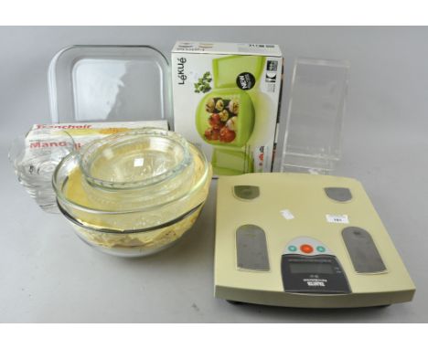 A collection of assorted kitchen glassware items, scales and a mandolin