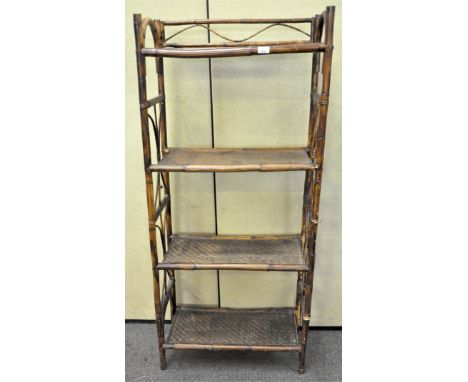 A 20th Century cane shelf having four shelves. Measures; H 154cm x W 67cm