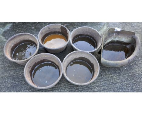 A cast iron triangular feeding trough with rounded edge, 68cm long, with five round feeders (6)