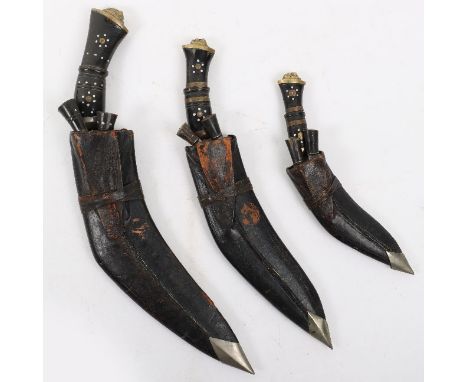 3x Nepalese Gurkha Kukris, being three sizes of Kukri knife all housed in the leather covered scabbards with skinning knives 