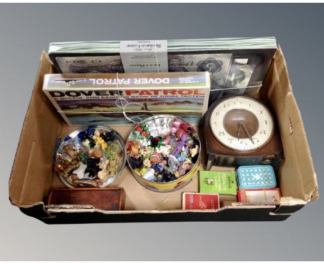 A box containing playing cards, board games, miniature ornaments including glass examples, Smith's mantel clock.