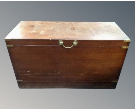 A mahogany brass bound shipping trunk.