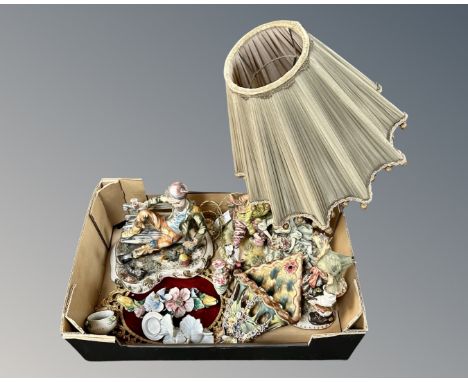 A box containing Italian figurines, a figural table lamp, wall pocket and plaque.