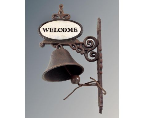 A cast iron welcome wall bracket with bell.