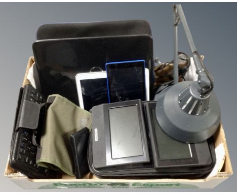 A box containing an angle poise lamp, a Dell laptop, assorted tablets, Garmin satnav etc.