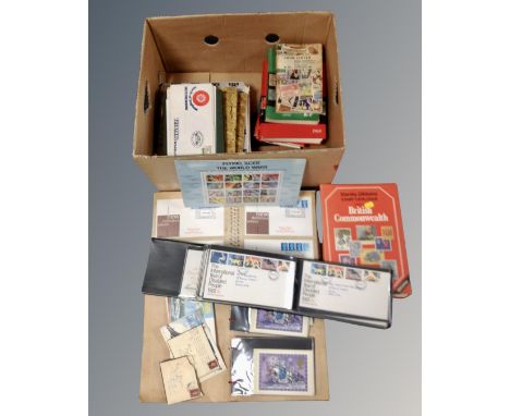 A box containing First Day Covers, stamp books, stamp albums containing antique and later world stamps.