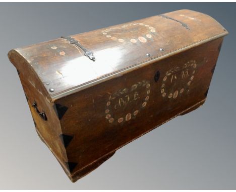 A 19th century Scandinavian oak dome topped shipping trunk with metal fittings and hand painted decoration.