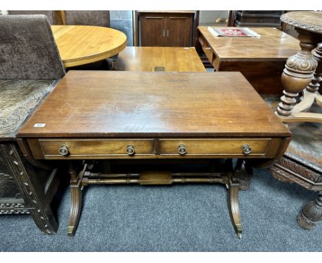 A mahogany Regency style sofa table fitted with two drawers.