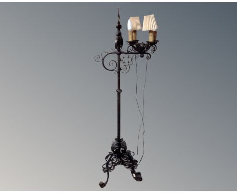 A 20th century wrought iron rise and fall standard lamp.