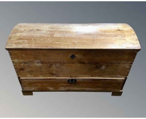 A 19th century pine dome topped shipping trunk fitted with a drawer.
