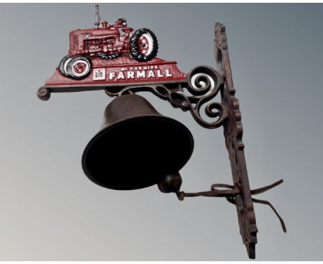 A cast iron Farnall tractor wall bracket with bell.