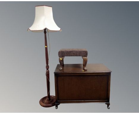 A 20th century oak panelled blanket box together with a footstool and a standard lamp with shade.