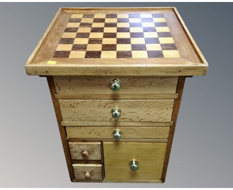 A six drawer chest with chessboard top together with a further chessboard, chess pieces and backgammon set.