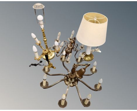 A continental brass eight way light fitting together with a further six way light fitting and three table lamps.