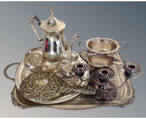 A silver-plated twin-handled tray together with a further serving tray, a three-piece plated tea service, a plated sauce boat