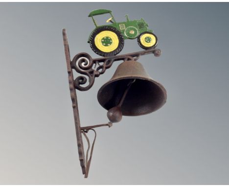 A cast iron tractor wall bracket with bell.