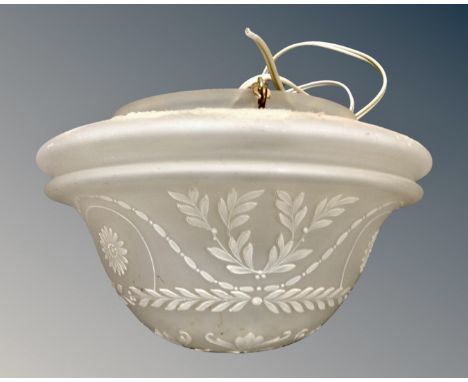 An early 20th century opaque glass light shade with hand painted decoration.
