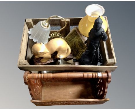 A vintage wooden crate containing a converted oil lamp, a metal figure of William the Conqueror, a pair of contemporary metal