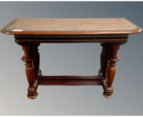 A mahogany and walnut low console table with mirrored back.