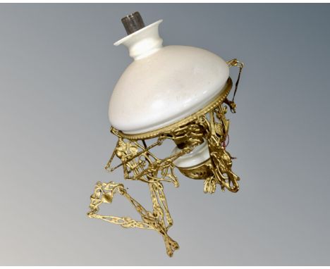 An antique gilt metal rise and fall oil lamp, with chimney and shade.