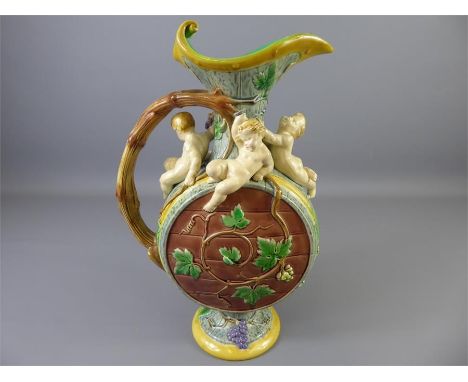 A Minton Majolica Ewer,&nbsp;earthenware moon-flask shaped body in grey, yellow and brown, with four putti in relief resting 