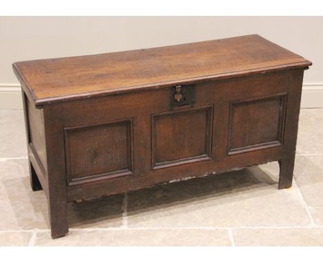 An 18th century and later oak coffer, the rectangular moulded top above three invert moulded front panels, raised upon stile 