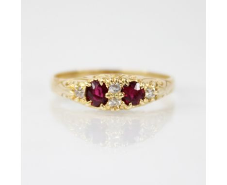 A Victorian ruby and diamond ring, comprising two oval mixed cut rubies, each measuring 4.2mm x 3.6mm and 3.9mm x 3.5mm, inte