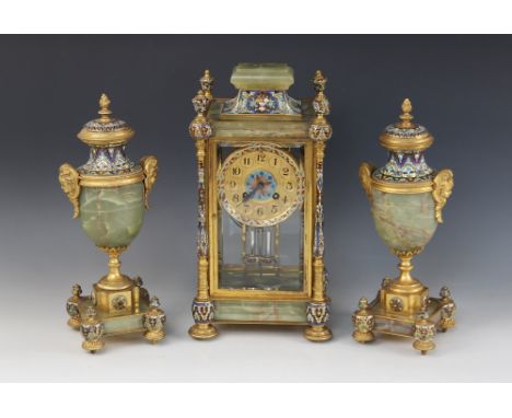 A late 19th/early 20th century French champlevé and green onyx clock garniture, the 11cm gilt metal dial applied with Arabic 