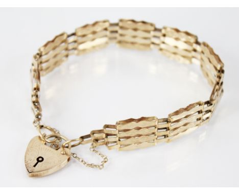 A 9ct gold gate link bracelet, the fancy brick links with engine turned detail, 19cm long, with heart-shaped padlock fastener
