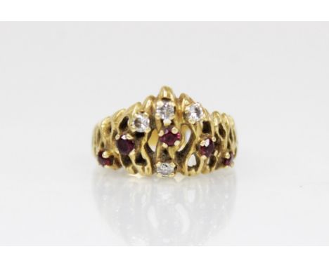 A ruby and diamond 18ct gold cocktail ring, the pierced organic chevron design ring set with round brilliant cut diamonds and