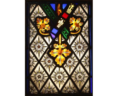 A stained glass window panel, 19th century and later, the glass pieces predominantly painted with Tudor white roses and folia