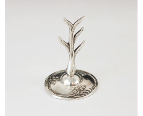 An Art Nouveau silver ring tree, WJ Myatt & Co, Birmingham 1917, the stylized silver tree upon a weighted circular base embos