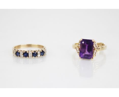 An Amethyst and diamond ring, the central rectangular step cut amethyst measuring 11.5mm x 8mm, claw set to a diamond set twi