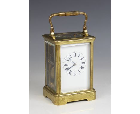 An early 20th century brass cased repeater carriage clock, the 6cm white enamelled dial applied with Roman numerals and enclo