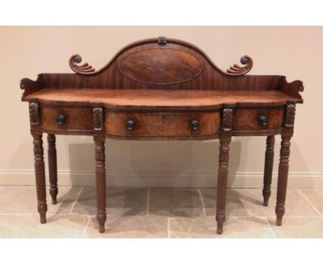 A George III mahogany sideboard, the break arch raised back with a rope twist 'moustache' top rail, above the galleried break