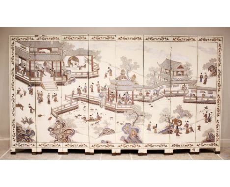A Chinese eight panel lacquered screen, early 20th century, the panels depicting figures in a village pagoda landscape upon a